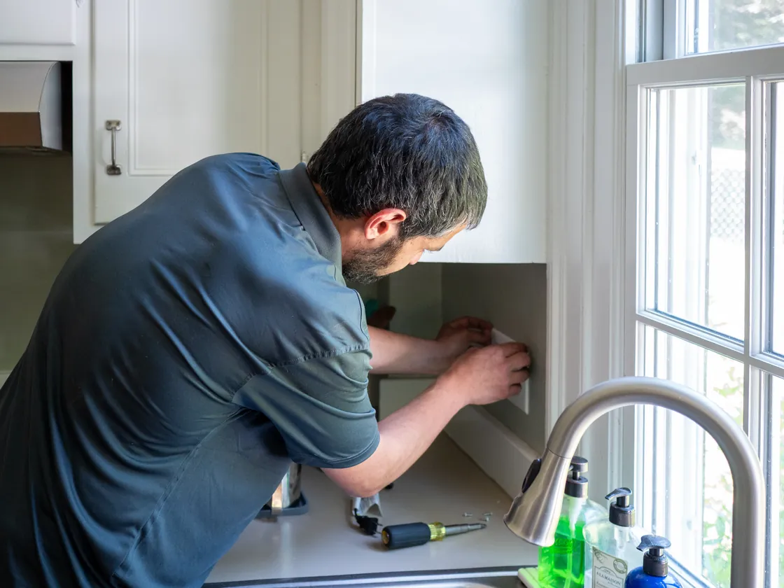 Endless Energy electrician installing a wall outlet in a kitchen