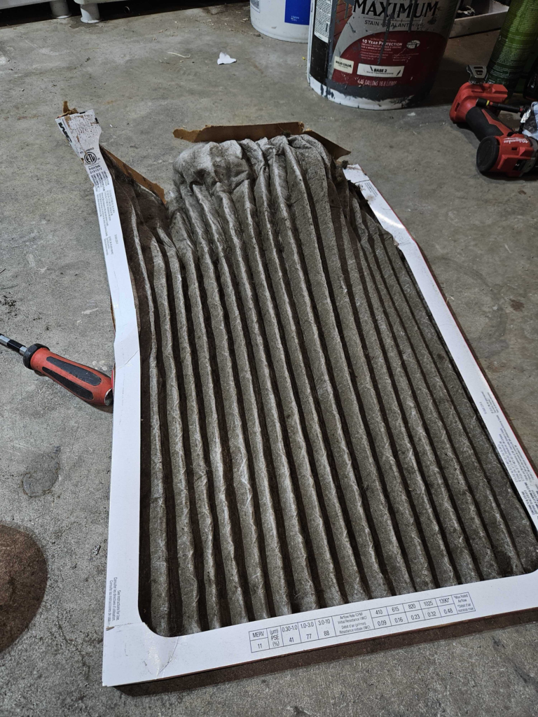 A dirty filter removed from a furnace during heating maintenance in Framingham Massachsetts by Endless Energy