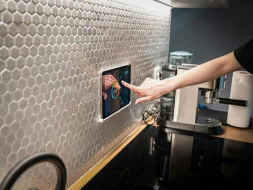 A woman adjusts her new energy-efficient HVAC system