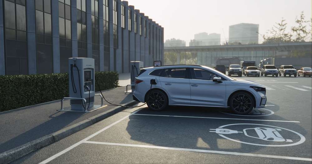 Electric car charging at station dock point in parking lot